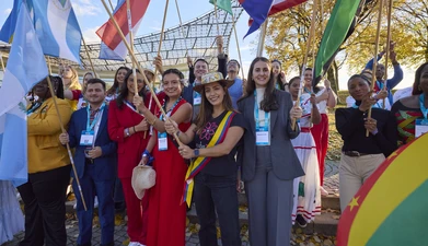 Delegates holding flags Munich 2025