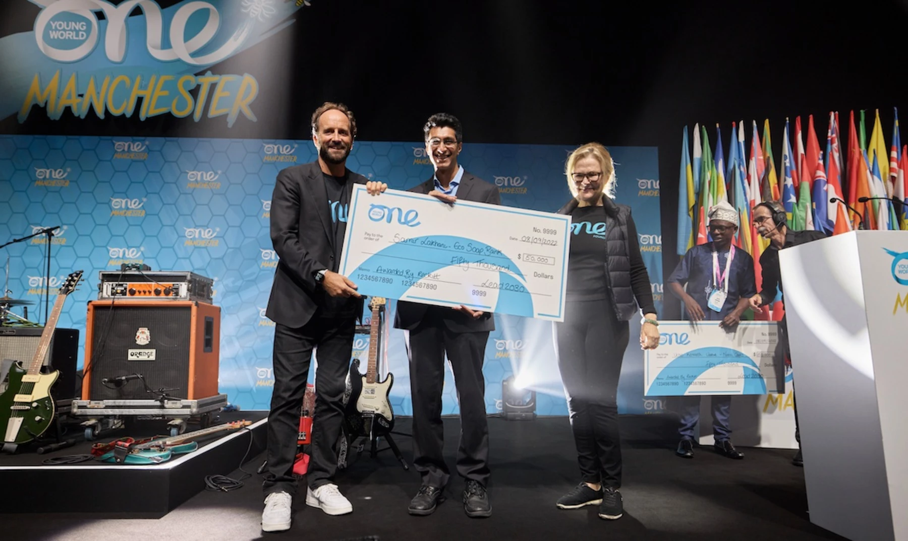 Samir Lakhani accepting his Lead 2030 award at the One Young World Summit Manchester, 2022