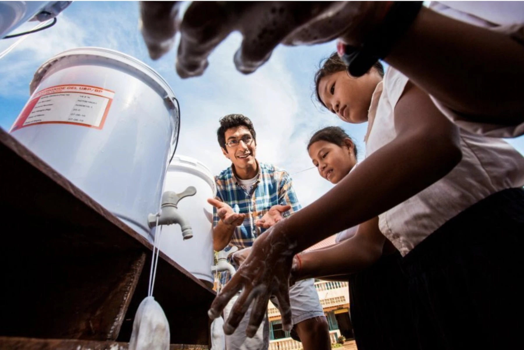 Samir Lakhani teaching a group of children about handwashing