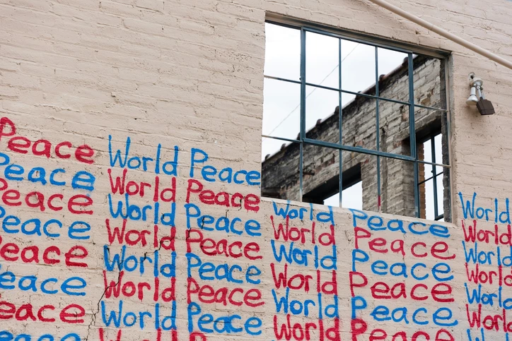 Wall with writing of "World Peace" in blue and red