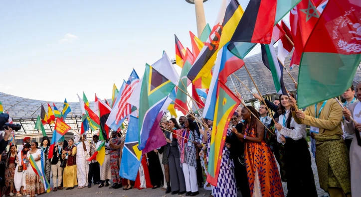 flag bearers waving flags at the summit